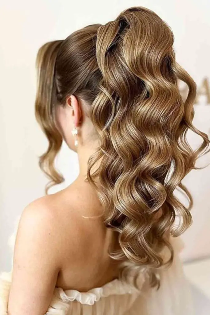 "High curly ponytail with added volume."