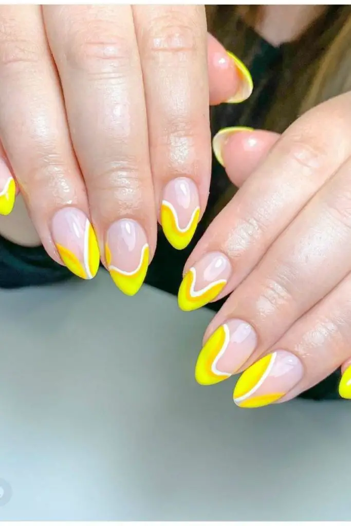 Flame-tip yellow nails with clear contrast.