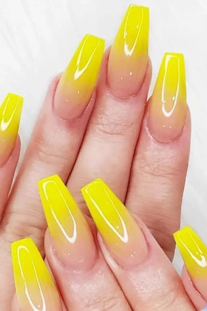 Warm yellow ombré fade nail design.