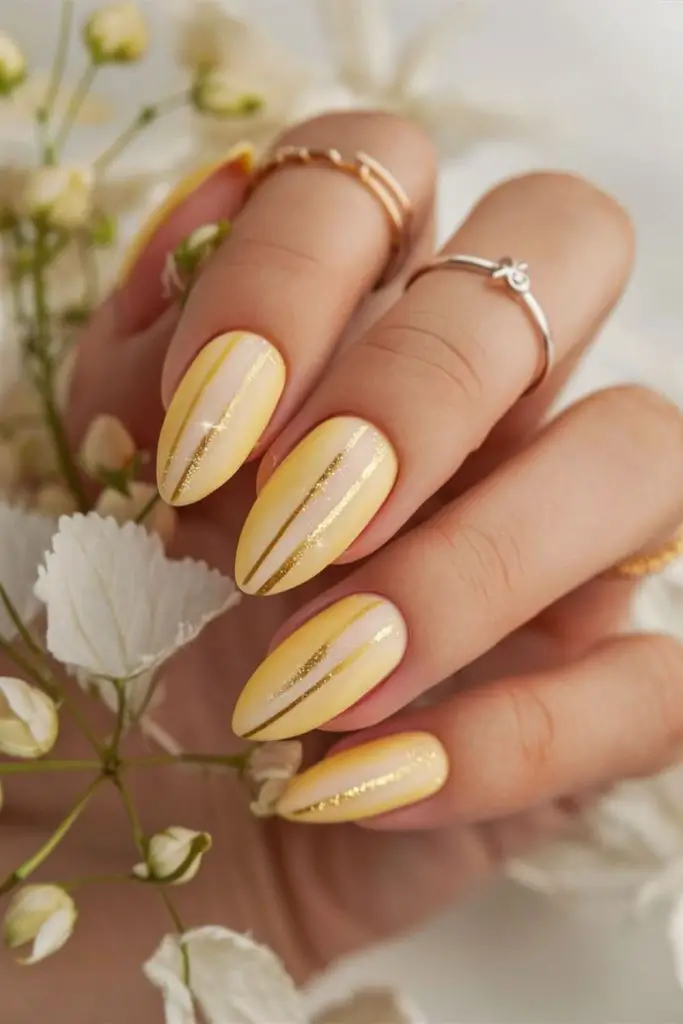 Yellow nails with scattered gold flecks.