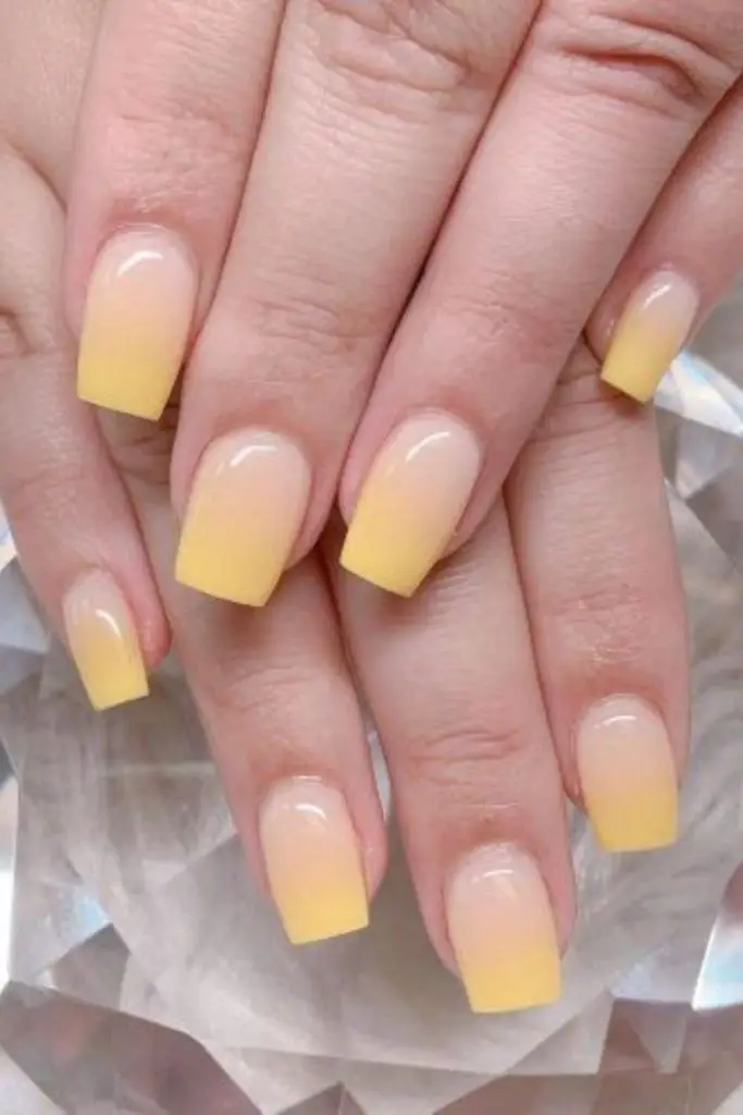 Yellow gradient nails with soft fade.