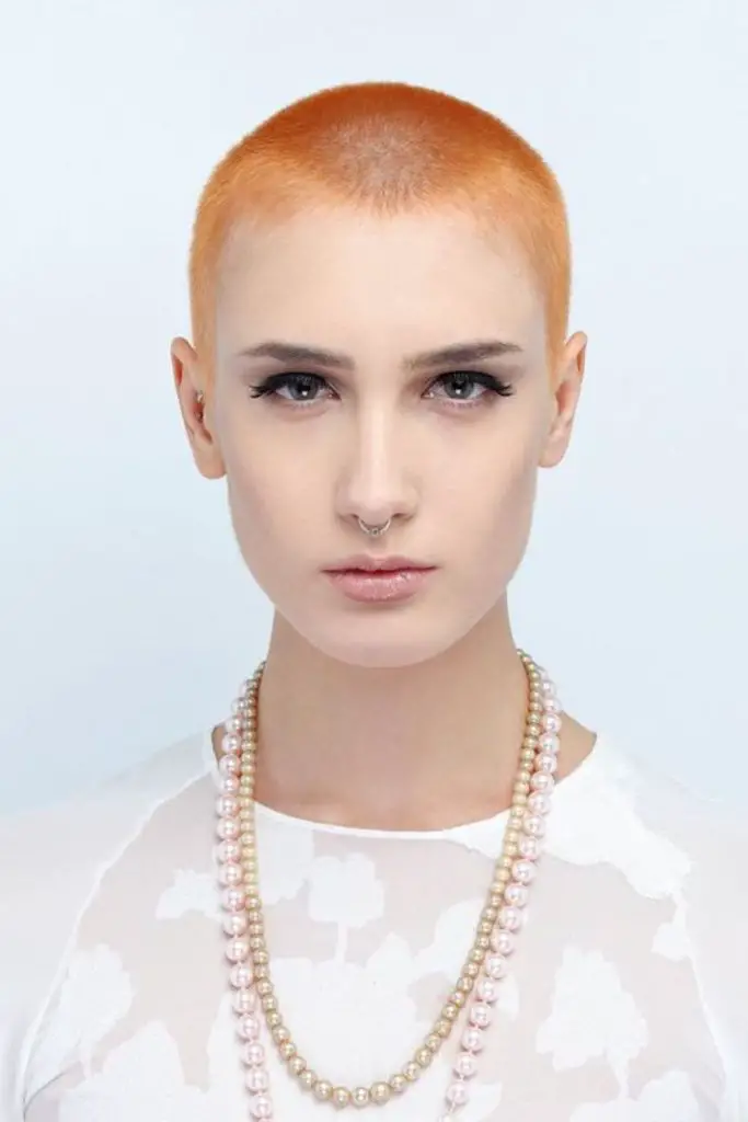 Fiery-toned crown with buzz fade.