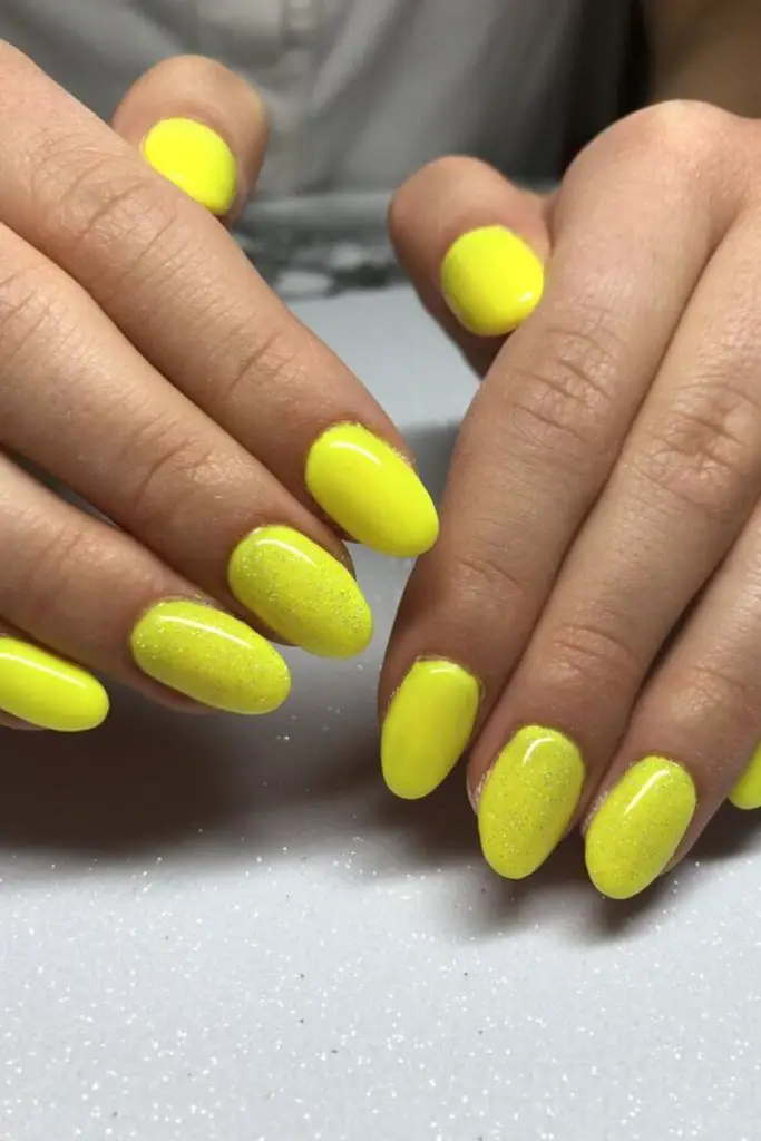 Neon pastel yellow high-gloss nails.