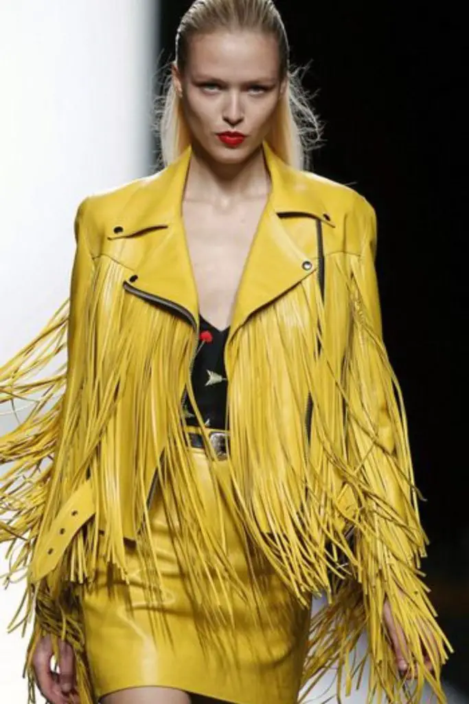 Yellow fringe jacket and printed unitard.