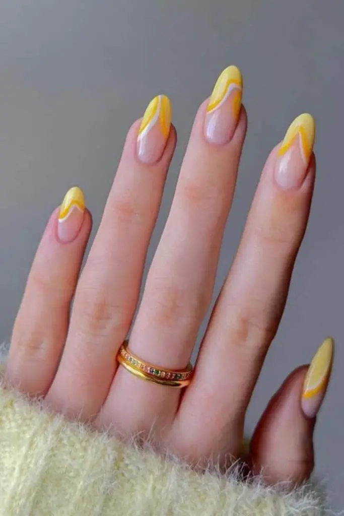 Yellow flame nail art on tips.