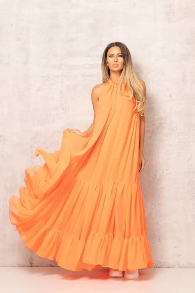 "Coral maxi dress with flowing skirt."