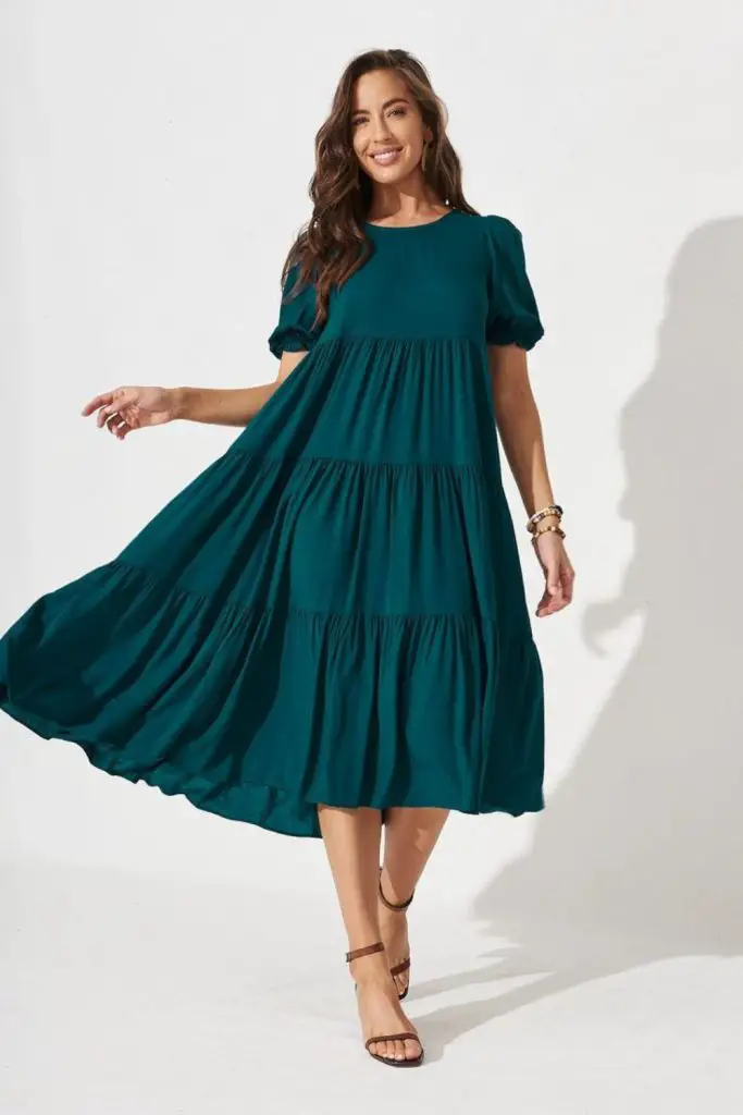 "Teal flowing dress with layered skirt."