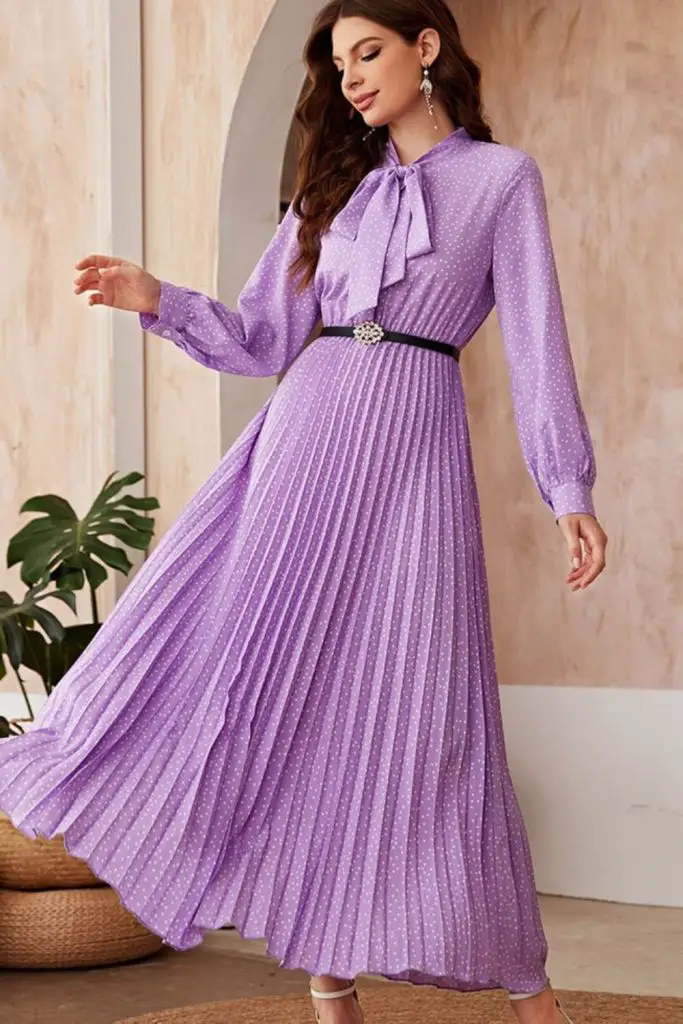 "Violet dress with pleated skirt flow."