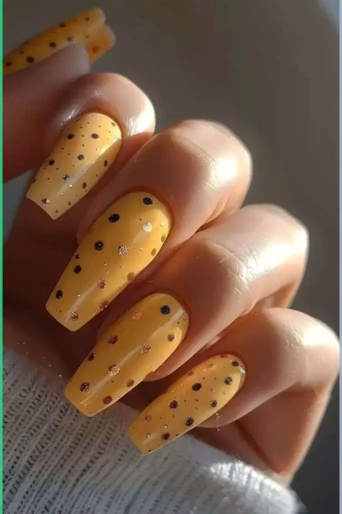 Glossy yellow nails with scattered bubbles