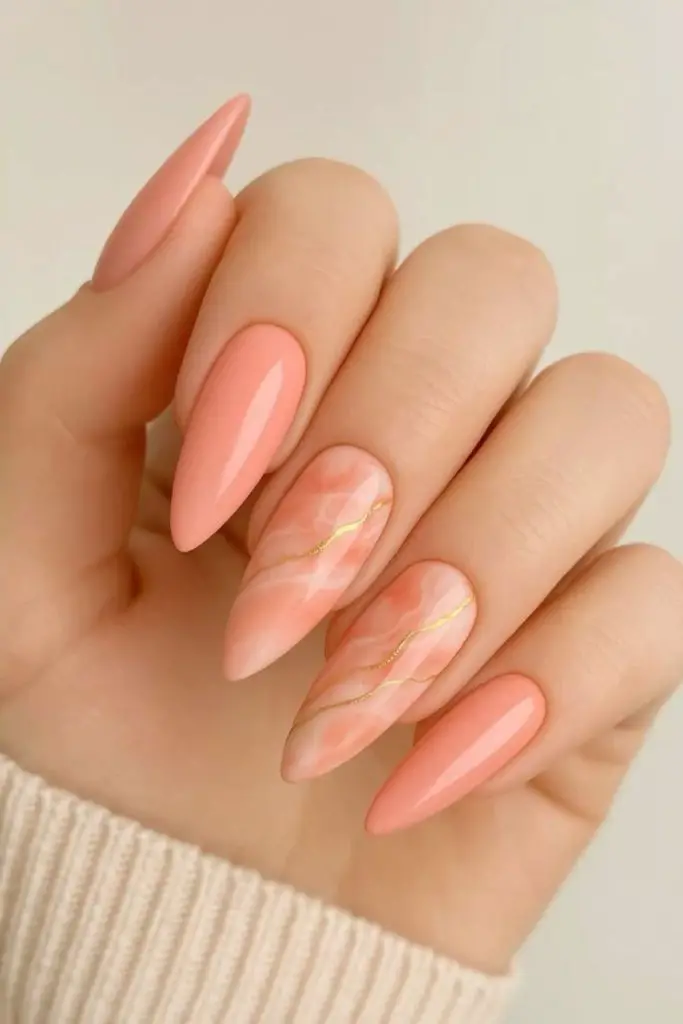 Glossy coral nails with gold foil.