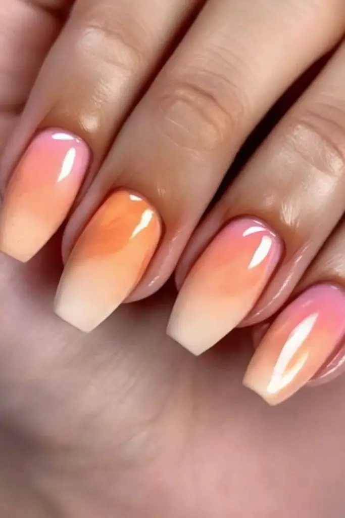 Glossy mango-toned coral melts over stiletto points