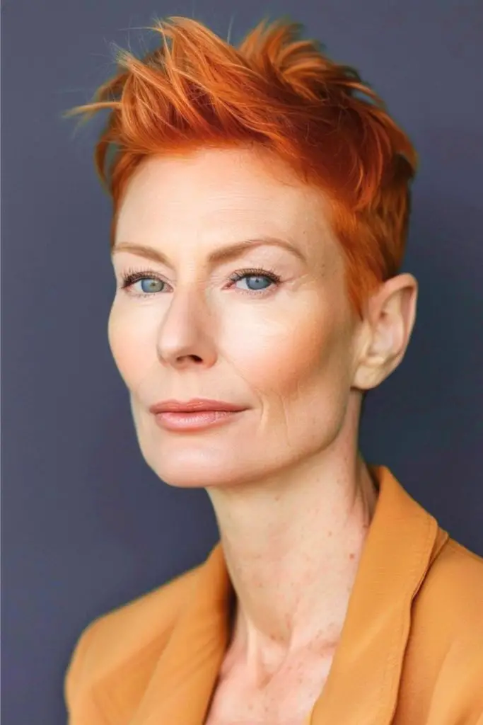 Vibrant saffron pixie with razor edges.
