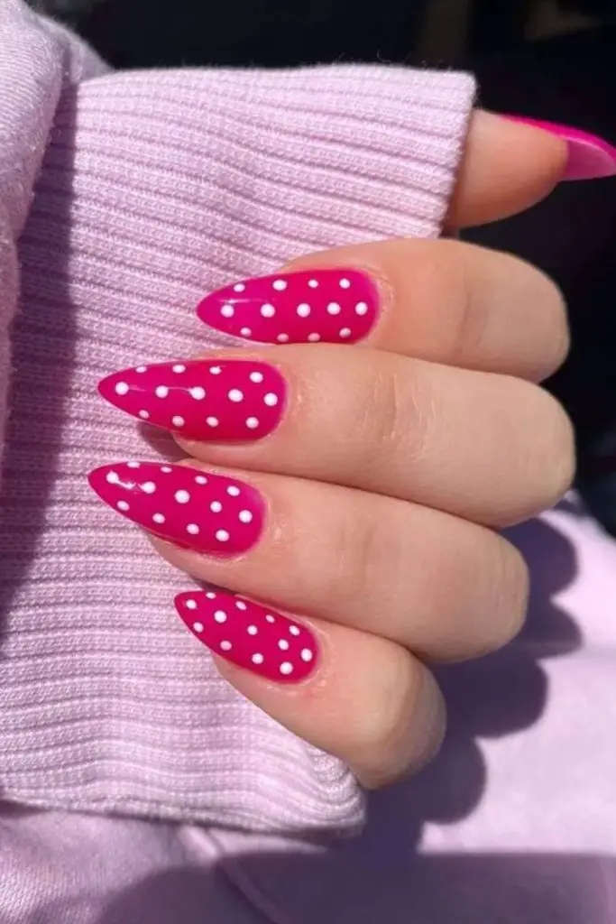 Pink nails with playful white dots.