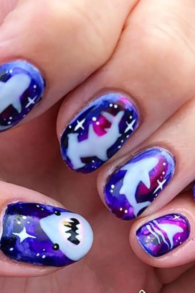 Plum-indigo nails with diagonal flecks.