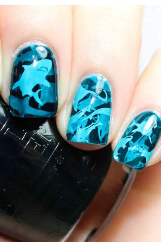 Teal polish with floating dot trails.