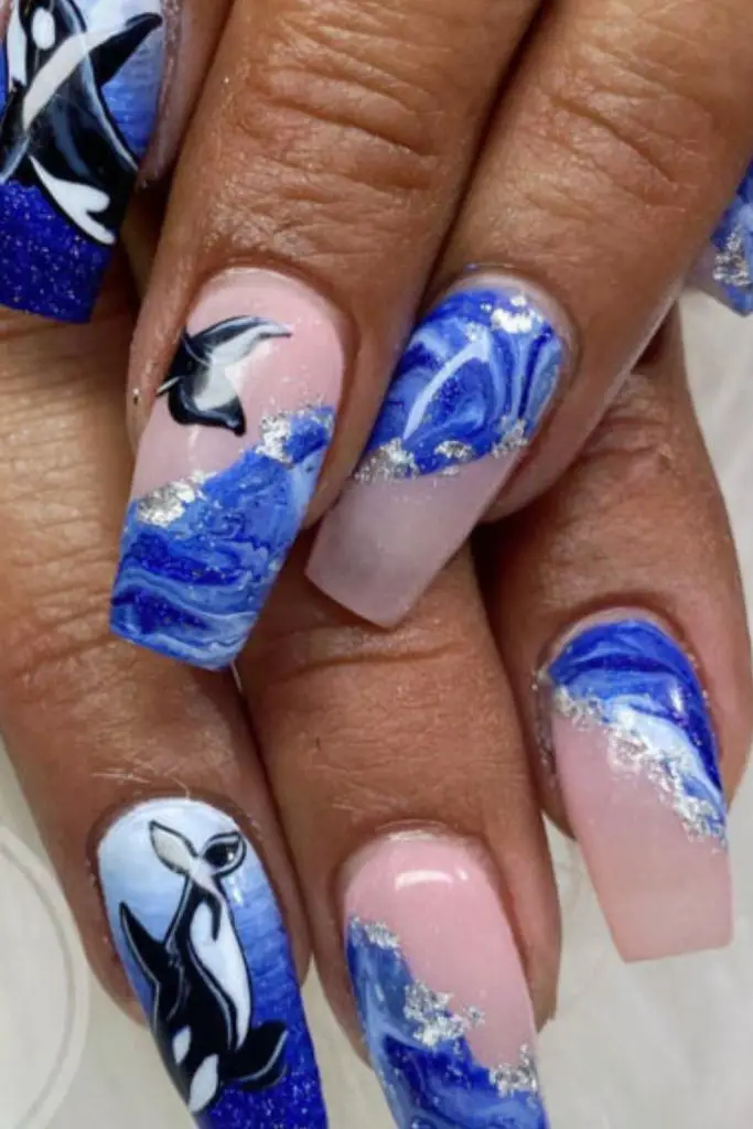 Navy galaxy nails with white spirals.