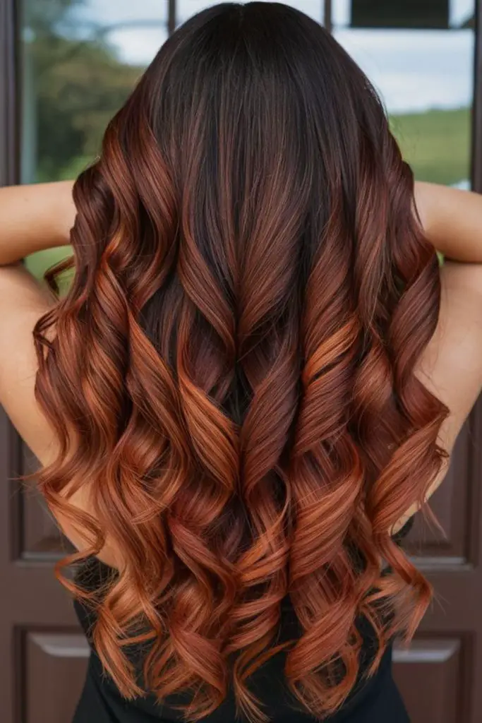 Fiery cinnamon swirls in brunette layers.