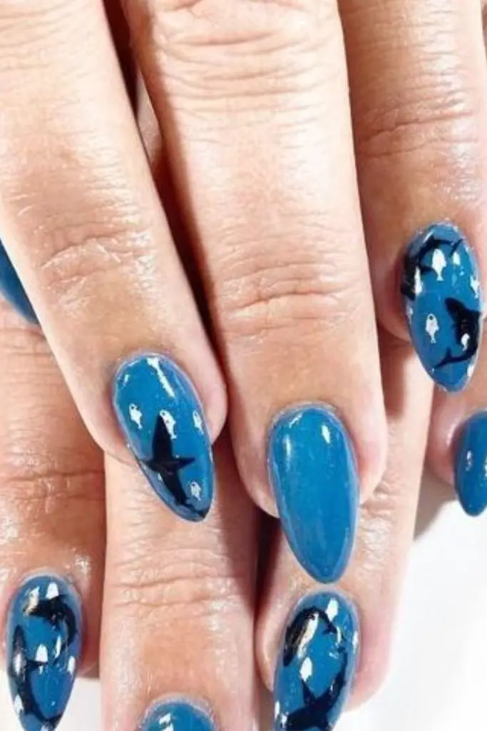 Bold cobalt nails with chaotic dots.
