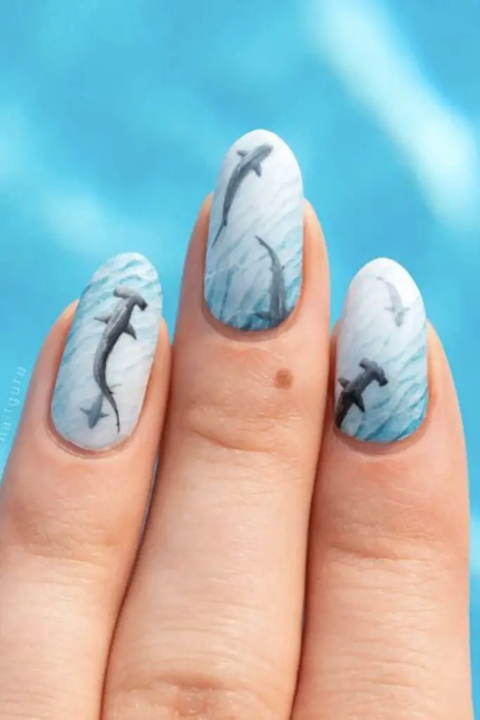 Misty aqua nails with white specks.