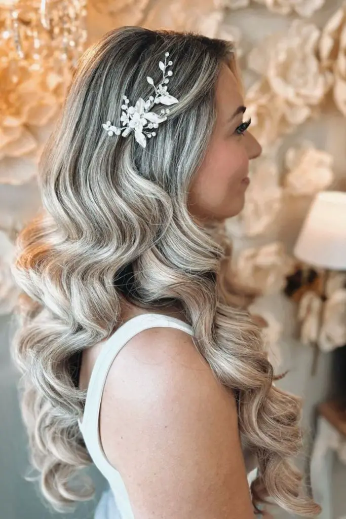 Elegant side-swept waves with pearl detail.