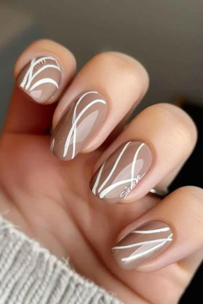 Tan nails with white stitched detail
