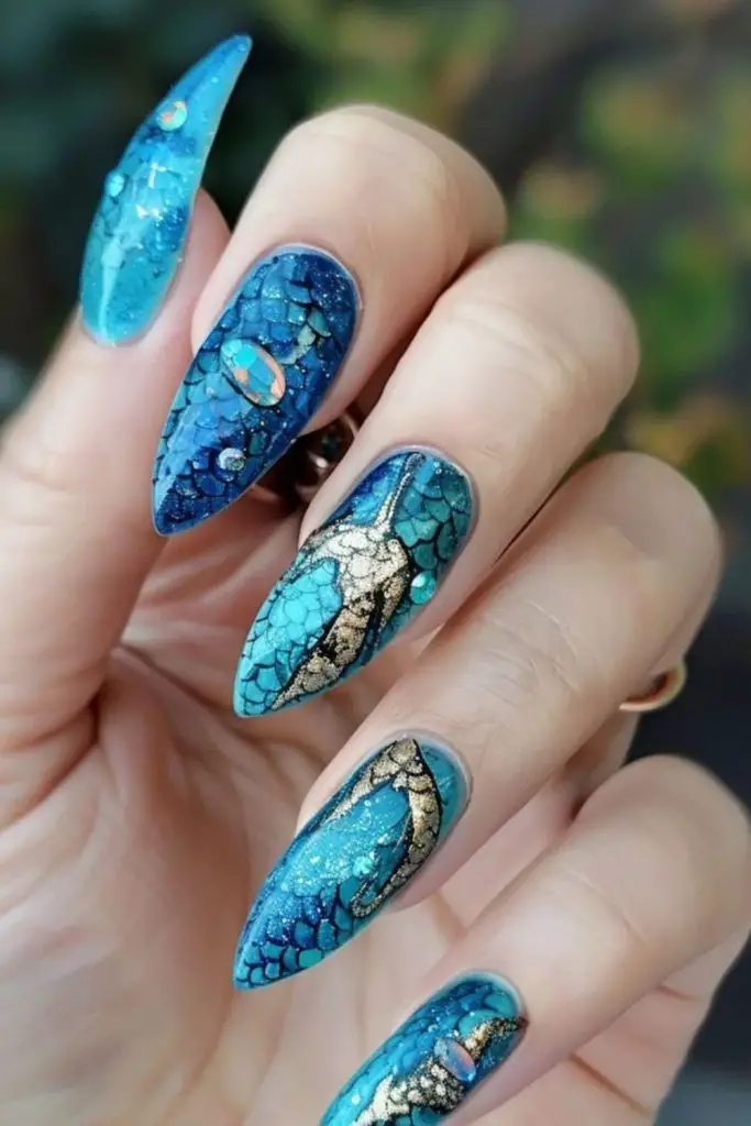 Indigo nails with gold-lined speckles.