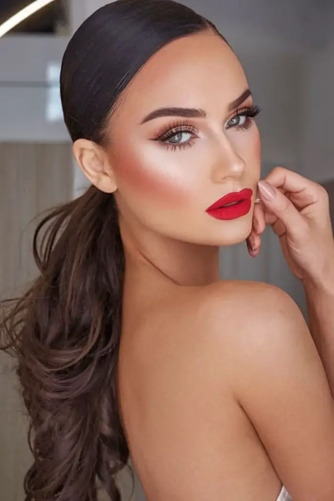Low side ponytail with dramatic part.