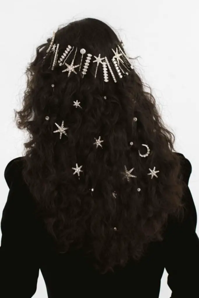 Star pins arranged across sleek hair.