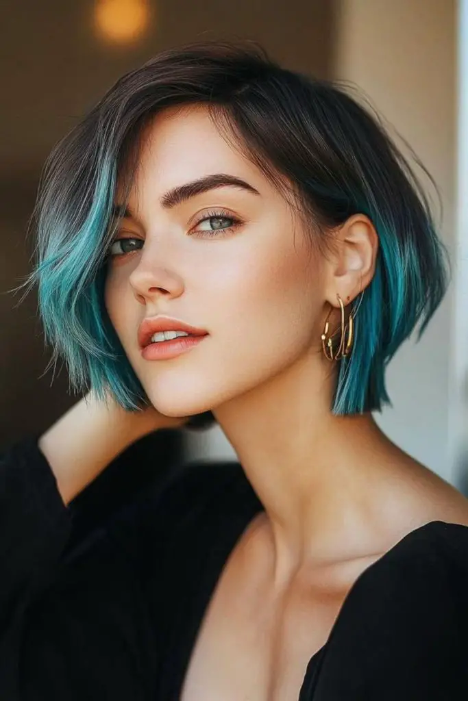 Teal chin bob with bold frame.
