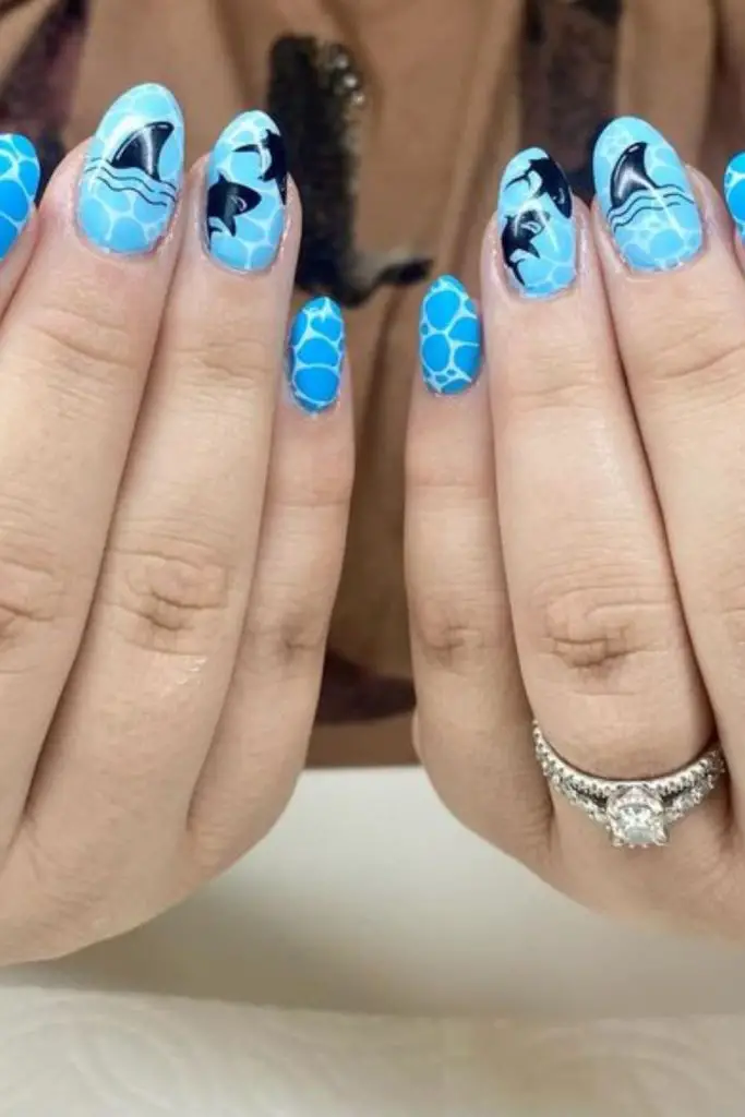 Milky nails with spiral speck patterns.