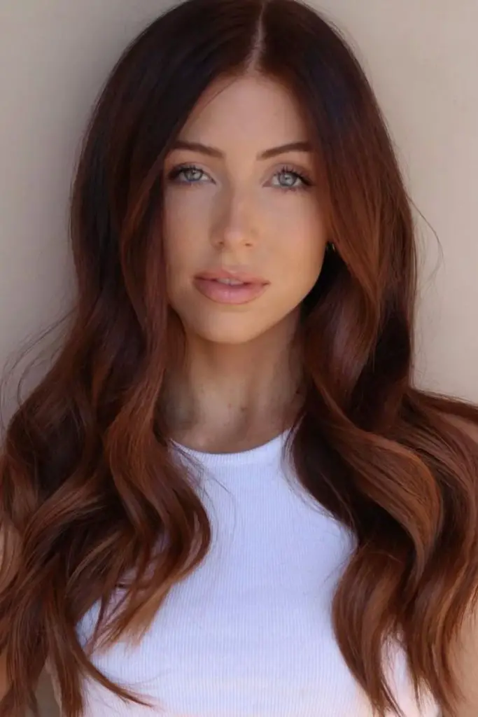 Rich auburn roots blending into bronze