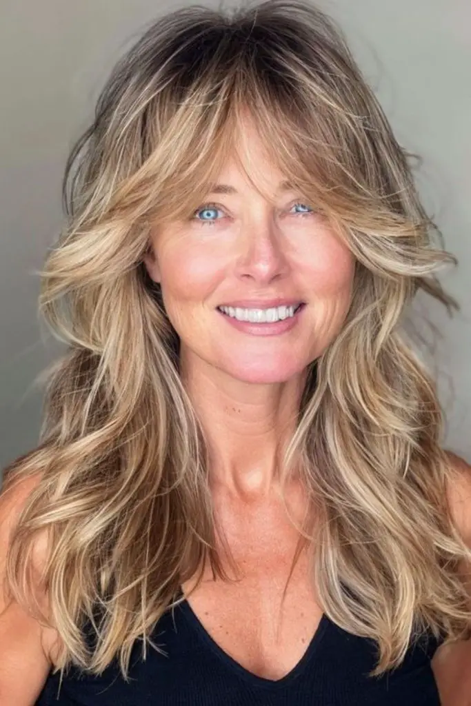 Chestnut waves with long feathered bangs.