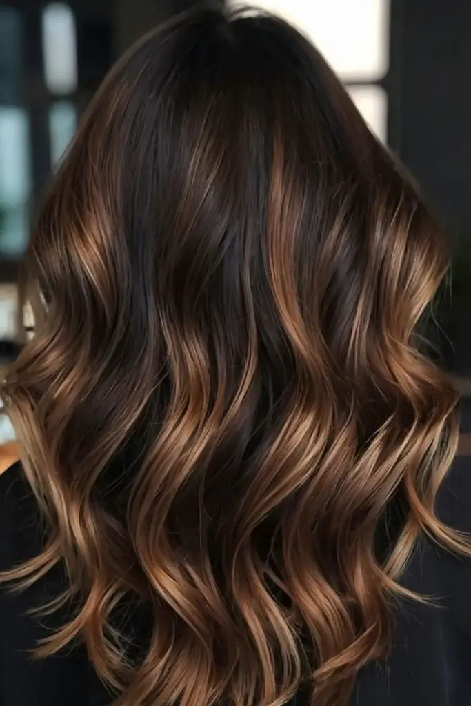 Burnt chestnut pulse through dark hair