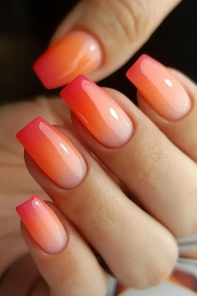 Coral sunset glow summer nail design.