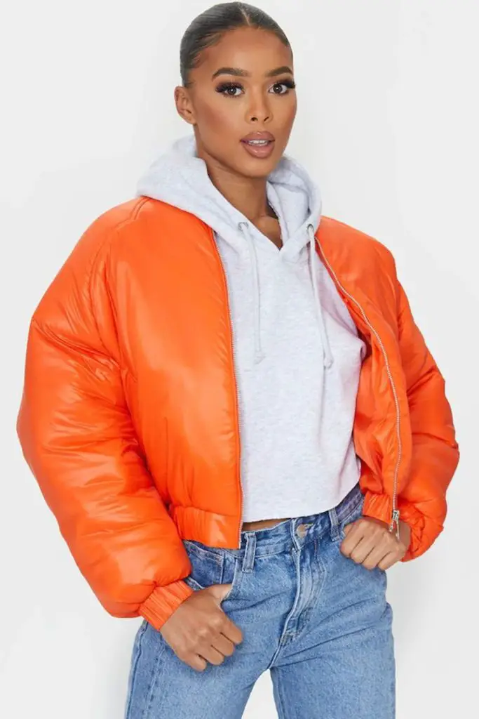 Burnt orange bomber with dark denim.