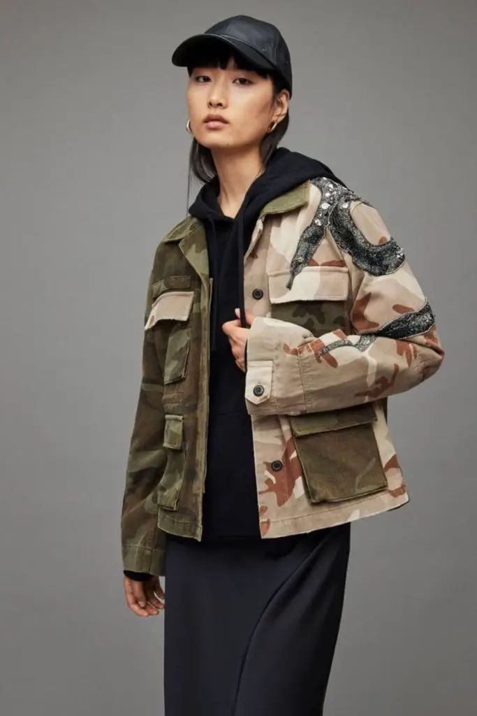 Military jacket over fleece hoodie.