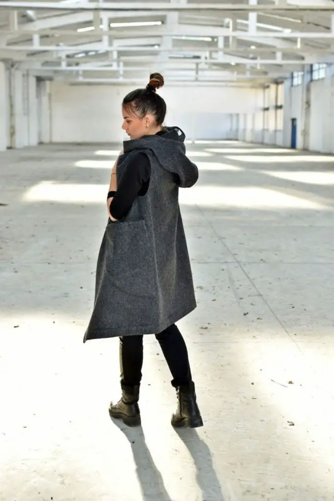 Oversized hoodie layered with quilted vest.