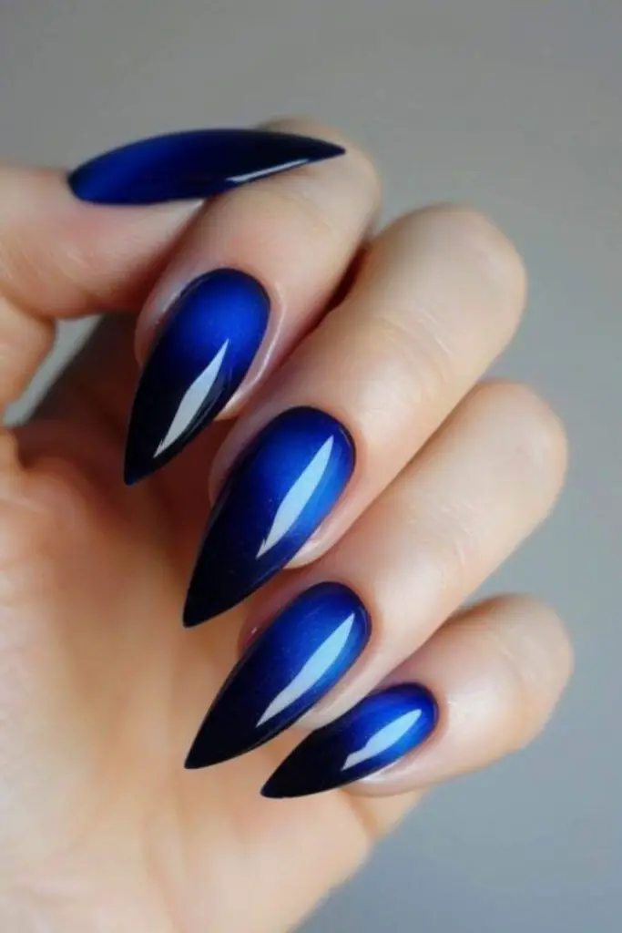 Indigo flame dramatic stiletto nails.