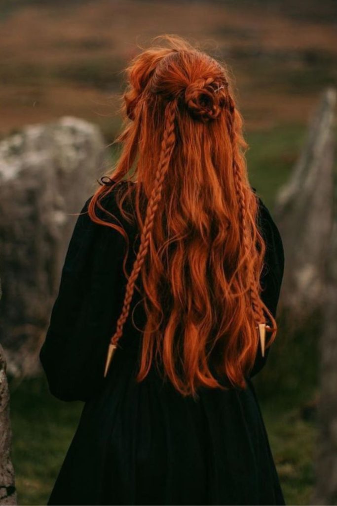 Medieval sorceress with scarlet braids.