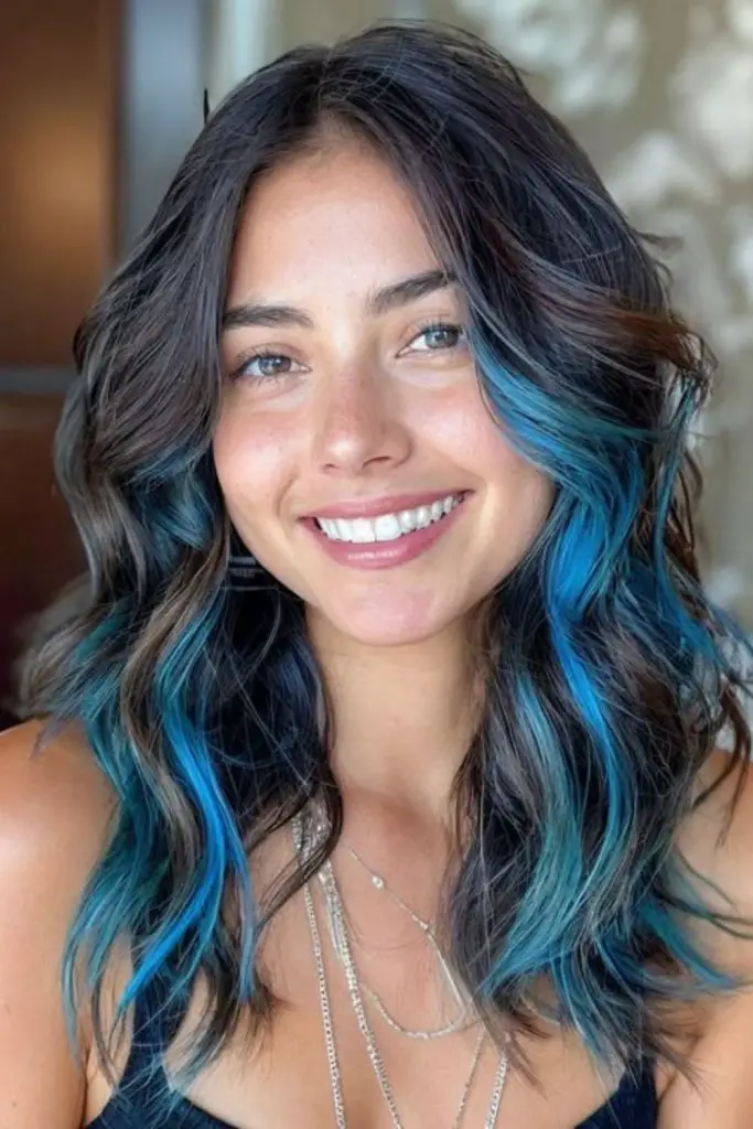 Aquamarine waves peeking through dark hair