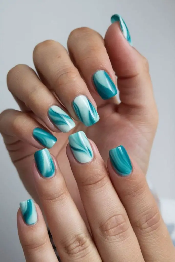 Ocean wave sparkle turquoise manicure.