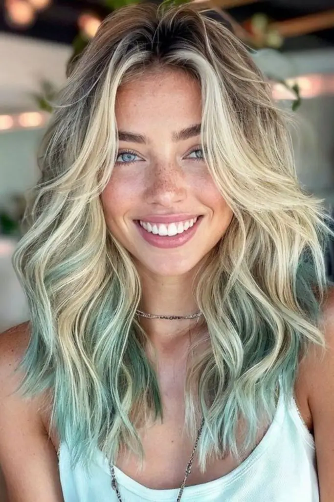 Pale green streaks in blonde hair