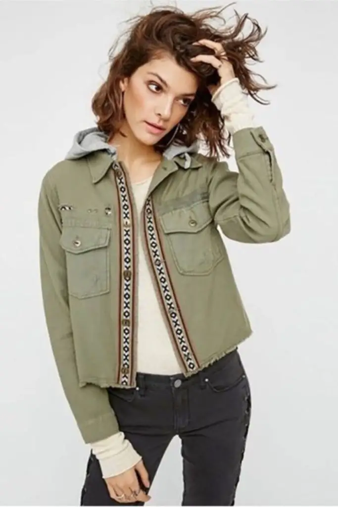 Cropped jacket layered over hoodie.