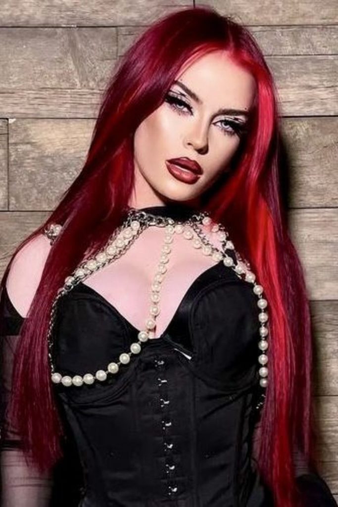 Ruby angel crowned with crimson feathers.
