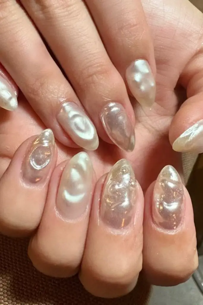 Seashell pearl iridescent nude manicure.