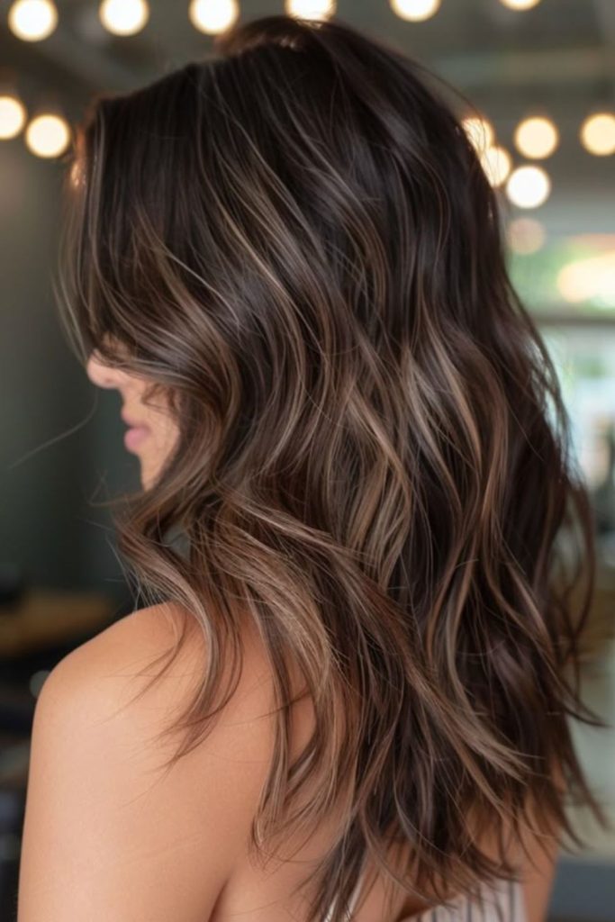 Smoky chestnut fade cool brunette look.