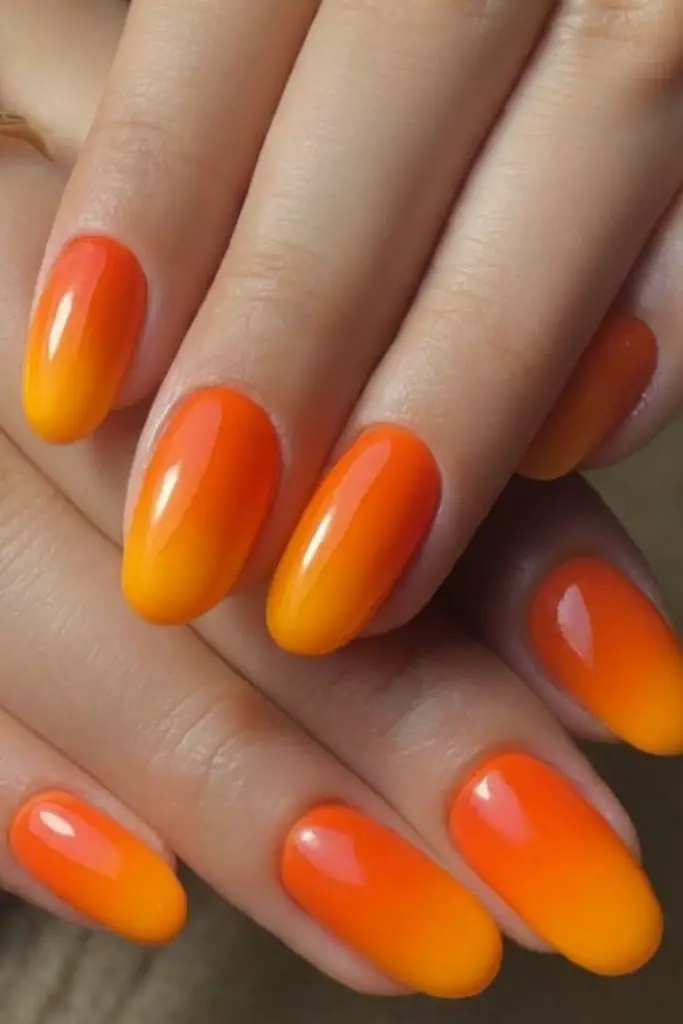 Tangerine dream bright ombre nails.