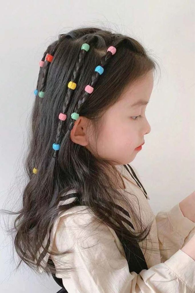 Waterfall braids flowing with shiny beads.
