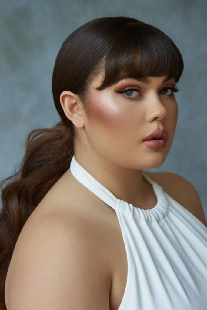 Curtain bangs with low ponytail