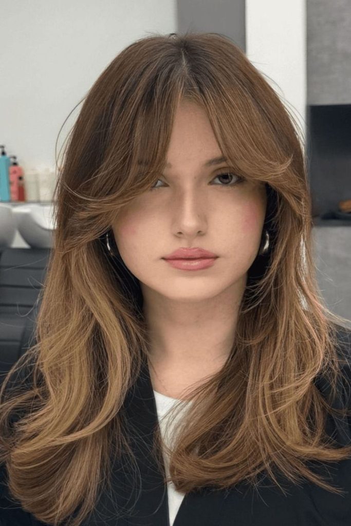 Feathered curtain bangs for round face